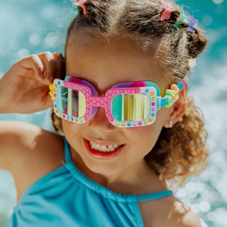 Bling2o Pretty Girl Poppy Flexible Frame Swim Goggle
Child wearing colorful sunglasses and a blue swimsuit with a pool background