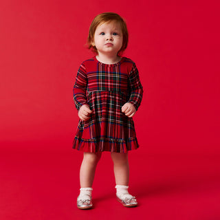 Posh Peanut Ruffled Bodysuit Dress - Red Tartan Plaid
Child wearing a red plaid dress on a red background