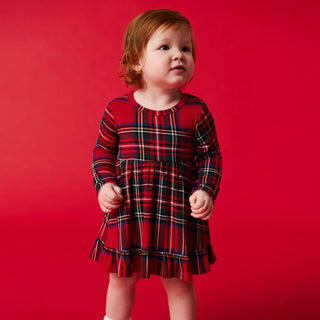 Posh Peanut Ruffled Bodysuit Dress - Red Tartan Plaid
Child wearing a red plaid dress against a red background
