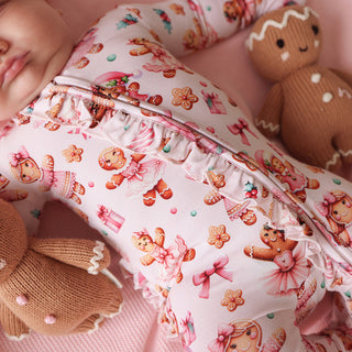 Posh Peanut Ruffled Zippered Footie - Ginger Posh
Baby in a crib with gingerbread-themed bedding and toys.