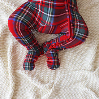 Posh Peanut Footie Zippered One Piece - Red Tartan Plaid
Red and blue plaid baby leggings on a beige blanket