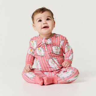 Posh Peanut Convertible One Piece - Sable
Baby wearing a pink and white patterned outfit on a white background
