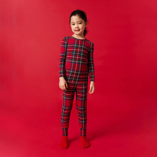 Posh Peanut Classic Pajama Set - Red Tartan Plaid
Child wearing red plaid pajamas on a red background