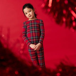 Posh Peanut Classic Pajama Set - Red Tartan Plaid
Child wearing a red plaid outfit against a red background