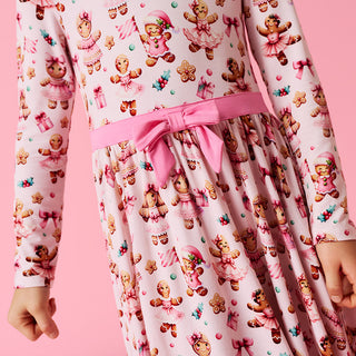 Posh Peanut Bow Twirl Dress - Ginger Posh
Children's dress with teddy bear and gingerbread man pattern on a pink background