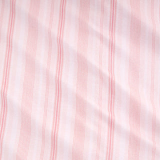 Posh Peanut Footie Ruffled Zippered One Piece - Remi
A close-up of a light pink and white striped fabric with vertical stripes and soft folds.