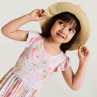 Posh Peanut Ruffled Twirl Dress in Rose Dreams, a charming children's dress with ruffles and a twirl skirt, styled for a lifestyle photoshoot.