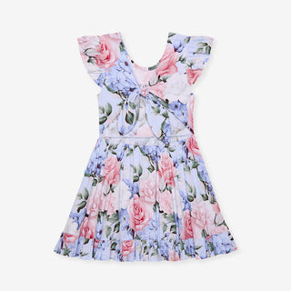 Posh Peanut Marion tie-back ruffled twirl dress shown from the back with ruffled hem and bow detail in soft pastel fabric.