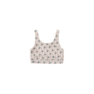Play by Rylee & Cru Swift Sports Bra - Blue Primrose
A sleeveless crop top with a dense small-scale floral print in navy blue and green on a warm beige background, shown flat against a solid white background.