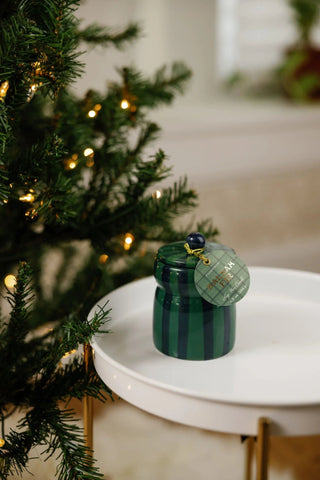 Paddywax Cabana 6.5 oz Balsam & Fir candle with lid, featuring a festive holiday design