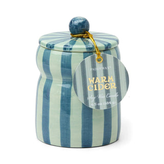 Paddywax Cabana 6.5 oz Candle with Lid - Warm Cider
A ceramic jar with a matching lid, featuring vertical stripes in blue and mint green, topped with a dark blue marble-like knob. A clear circular tag attached with a gold string reads 'PADDY WAX WARM CIDER'.