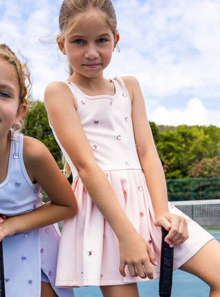 Lola & The Boys peach heart scuba tennis dress displayed on a hanger, showcasing its vibrant color and fitted design.