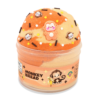 Peachybbies Cloud Slime - Monkey Bread
A novelty toy or squishy shaped like a donut, labeled 'MONKEY BREAD,' with a peach and beige marbled surface, sprinkles, and cartoon monkey decorations on top, shown in a clear round container against a white background.