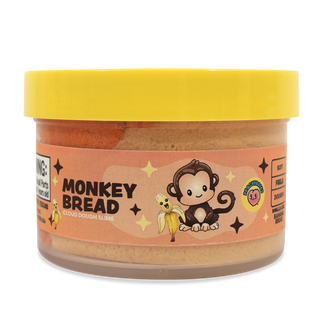 Peachybbies Cloud Slime - Monkey Bread A jar of Monkey Bread cloud dough cookie by Sweetener Snobs, featuring a bright yellow lid and a peach-colored label with a cartoon monkey and banana illustration.