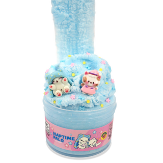 Peachybbies Cloud Slime - Naptime Pals A light blue slime container with a pink label reading 'NAPTIME PALS' and two small plush toy figures on top of the slime, photographed on a plain white background.