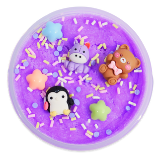 Peachybbies Cloud Slime - Plushie Pile A round purple slime or playdough container filled with bright purple material, decorated with colorful sprinkles and small animal-shaped charms including a penguin, unicorn, teddy bear, and star shapes.