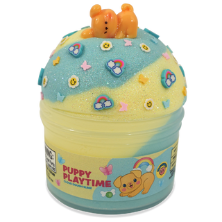 Peachybbies Cloud Slime - Puppy Playtime
A cupcake-shaped slime toy with yellow and light blue swirls, decorated with small rainbow, cloud, smiley face, and butterfly charms, topped with an orange puppy figure. The container has a printed label reading 'PUPPY PLAYTIME'.