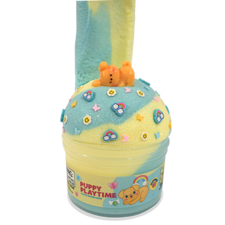 Peachybbies Cloud Slime - Puppy Playtime
A round container of pastel slime with a lid topped by a small orange bear figure. The slime is marbled light blue and pale yellow, decorated with colorful flower and heart stickers, on a plain white background.