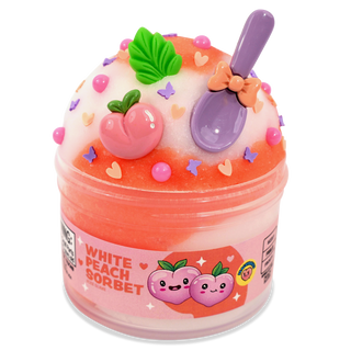 Peachybbies Icee Slime - White Peach Sorbet
A small plastic tub of white peach sorbet slime with a decorative lid featuring a peach, green leaf, purple spoon, and pastel sprinkles. The label reads 'WHITE PEACH SORBET'.