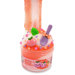 Peachybbies Icee Slime - White Peach Sorbet
A pink and orange slime toy shaped like a dessert cup, labeled 'WHITE PEACH SORBET,' with a peach-colored slime tail rising from the top, decorated with a small purple spoon, peach, green leaf, and colorful sprinkles on a white background.