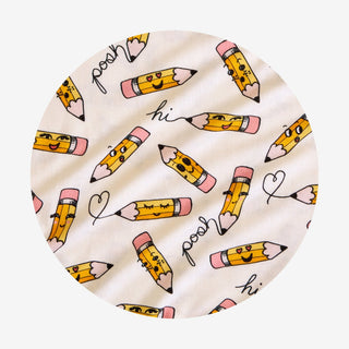Posh Peanut Posh Pencils Ruffled Twirl Dress Round fabric swatch with colorful pencil pattern on a white background