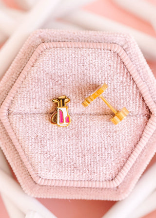 Pierced Co. Golf Bag Earrings
Gold and pink earrings on a pink textured jewelry box