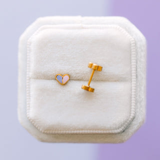 Pierced Co. Micro Heart Duo Earrings
Heart-shaped earrings on a white jewelry box with a purple background
