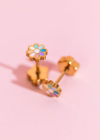 Pierced Co. Rainbow Tiny Daisy Earrings
Gold flower-shaped earrings with colorful centers on a pink background