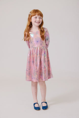 Pink Chicken Girls Lame Steph Dress - Pink Spider Web
Young girl wearing a pink floral dress on a plain background