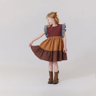 Pink Chicken Girls Kit Dress - Mixed Checks
Young girl wearing a three-tone dress with ruffled sleeves on a plain background