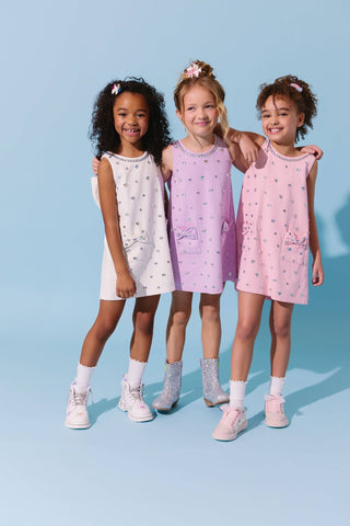 Pink denim dress with crystal heart embellishment and bow detail from Lola & The Boys, perfect for stylish young girls.