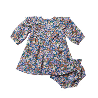 Pink Chicken Baby Girls Everly Dress Set - True Blue Sketched Floral A toddler girl's floral print dress with long ruffled sleeves and matching ruffled bloomers, laid flat on a light gray background.