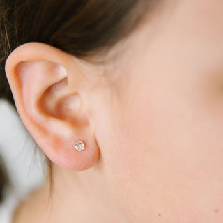 Gold diamond stud earrings from Pip Pop Post featuring sleek, minimalist design with sparkling diamond accents.
