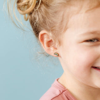Pip Pop Post Earrings - Pastel Rainbow
Child wearing rainbow-shaped earrings against a light blue background