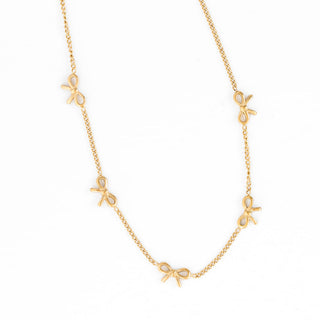 Pip Pop Post Bow Repeat Necklace
Gold necklace with bow-shaped charms on a white background