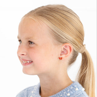 Pip Pop Post Earrings - Red Enamel Bow
Young girl with blonde hair in a ponytail wearing a blue sweater on a white background