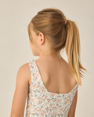 Play by Rylee & Cru Malibu Bodysuit - Flower Field
Back view of a child wearing a floral dress with a plain background