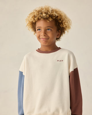 Play by Rylee & Cru Relaxed Sweatshirt - Natural
Child wearing a color-blocked sweatshirt with 'PLAY' text on a plain background