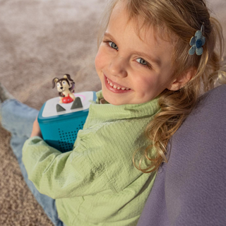 Playtime Puppy Toniebox 2 Starter Set - Tropical Teal
Child holding a toy with a small figurine on top, sitting on a carpeted floor.