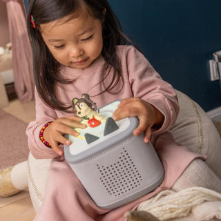 Playtime Puppy Toniebox 2 Starter Set - Moon Gray
Child playing with a toy radio in a cozy room