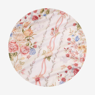 Posh Peanut - Janey
A circular fabric swatch featuring a delicate vintage floral pattern in soft pink, red, blue, and yellow tones on a cream background, with vertical pink ribbon motifs and green leafy accents.
