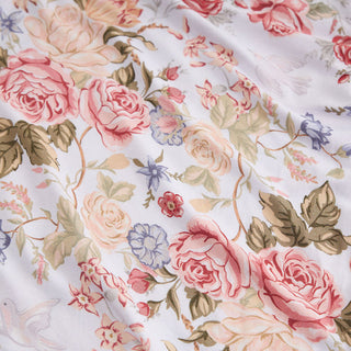 Posh Peanut - Kristiana
A close-up of a white fabric with a vintage floral print featuring pink and peach roses, green leaves, and small blue flowers.