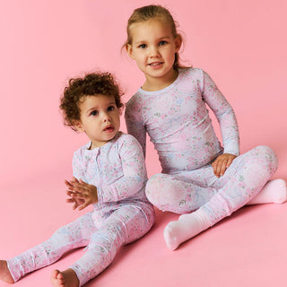 Posh Peanut Classic Pajama Set - Josephine
Two children wearing matching floral pajamas on a pink background