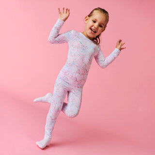 Posh Peanut Classic Pajama Set - Josephine
Child wearing a pink and white patterned outfit on a pink background
