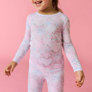 Posh Peanut Classic Pajama Set - Josephine
Child wearing a floral long-sleeve shirt and pants on a pink background