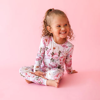 Posh Peanut Classic Pajama Set - Lucienne
Child wearing floral pajamas sitting on a pink background