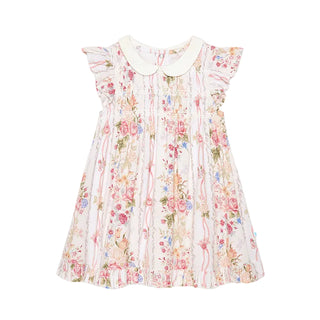 Posh Peanut Collared Smocked Ruffled Dress - Janey
A toddler girl's sleeveless dress with a cream Peter Pan collar, featuring a smocked bodice and a ruffled skirt in a pink, red, and blue floral pattern on a cream background.