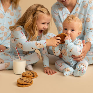 Posh Peanut Convertible One Piece - Chocolate Chip Cookies
Two children in matching pajamas with cookie design, eating cookies and drinking milk.