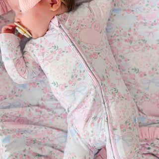 Posh Peanut Convertible One Piece - Josephine
Baby in a floral onesie lying on a matching blanket