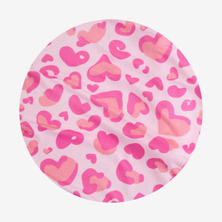 Posh Peanut Love Leopard
Round pink fabric with heart pattern on a white background